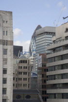 The Gherkin Swiss Re building seen  through tightly huddled buildings in the city  from London Bridge.United Kingdom Great Britain UK