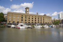 St Catherine s Dock with yachts moored next to the former warehouses which are now luxury apartments.United Kingdom Great Britain UK