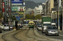 Kanko dori - cars tram and tramlines in main downtown shopping streetAsia UrbanTransport