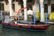 A postal service barge collecting mail from the main post office on the Grand Canal beside the Rialto Bridge