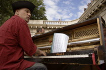 The Paris Plage urban beach. A singer playing a piano to an audience under the Pont Notre Dame on the Voie Georges Pompidou a usually busy road closed to traffic