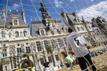 The Paris Plage urban beach. Boy wearing a Zidane football shirt playing in goal during a beach soccer childrens match in front of the Hotel de Ville Town Hall