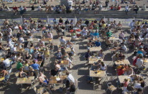 People sat at tables drinking outside the Beach seafront bar.Great Britain United Kingdom