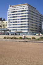 Embassy Court restored Art Deco apartment block on the sea front  with petanque pitch in the foreground.Great Britain United Kingdom