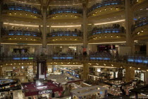 Opera Quarter. The central circular area under the glass dome of the Art Nouveau department store Galleries Lafayette showing the balconies and the perfume department on the ground floorShop European...