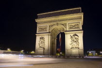 Streaked lights of traffic passing the Arc de Triomphe illuminated at nightEuropean French Nite Western Europe