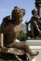 Art Nouveau cherubs on a lamp-post on Ponte Alexandre III bridge across the River Seine named after Tsar Alexander III of Russia with the Grand Palais beyondEastern Europe Europe & Asia European Fren...