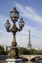 Art Nouveau lamp-post on Ponte Alexandre III bridge across the River Seine named after Tsar Alexander III of Russia with the Eiffel Tower in the distanceEastern Europe Europe & Asia European French R...