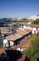 The Basque seaside resort on the Atlantic coast. Seafood restaurants in the Port des Pecheurs with the Grande Plage and town beyond