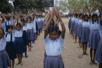 Primary school children starting day with physical exercise.