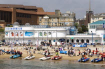 The West Beach from The Pier with the BICC Bournemouth International Conference Centre and Oceanarium behind. Contestants for Zapcat inflatable speedboat races watch the races from the beach