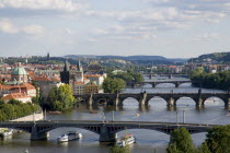 The city skyline with the bridges across the Vtlava River and cruise ships passing beneath them