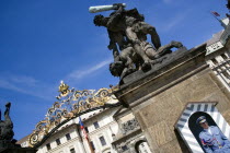 The entrance to Prague Castle with a sentry standing guard beneath an 18th Century statue of fighting giants by Ignaz Platzer