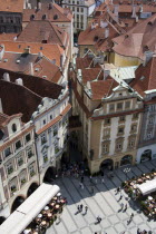 Restaurant and cafe tables with strolling pedestrians in the Old Town Square