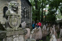 The tombstone of the Jewish nobleman Hendela Bassevi outside the Neo-Romanesque Ceremonial hall amongst densely packed gravestones in the Jewish Cemetary