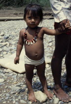 Choco Indian girl wearing monkey tooth necklace.