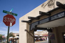 Stop sign on the Old Santa Fe Trail beside and adobe Pueblo Revival style building