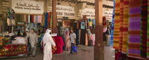 Fabric traders and shoppers in Bur Dubai Souq.TravelTourismMerchantsCommerceTradeCloth Dubayy United Arab Emirates