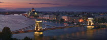 View of Parliament and Szechenyi Lanchid  Chain Bridge from the Royal Palace at dusk.TourismTravelHolidaysPanoramaRiver DanubeEastern Europe