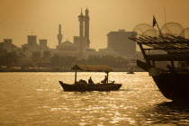 Abra boat on Dubai Creek with the Grand Mosque behind.SkylineHolidaysTourismTravelSilhouetteTransportBoat DhowGold Dubayy United Arab Emirates