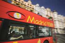 Red sight seeing bus on the Gran Via.LeisureTravelHolidaysTourismLogo