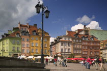 Plac Zamkowy  Castle Square in the Old Town. Outside seating  tables with parasols  lamppost and pedestrians.TourismTravelHolidaysEastern Europe