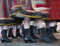 Detail of traditional dancers costumes performing in the Old Town. Moving  blurred skirts and boots.Eastern EuropeHolidaysTravelTourismColourNational DressMovementColor
