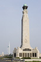 World War One Naval Memorial obelisk on Southsea seafront designed by Sir Robert Lorimer with sculpture by Henry Poole with the Spinnaker Tower and the Anglican Cathedral Of St Thomas beyond