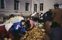 Group of men and women preparing vegetables for pickling  a staple of the Korean diet called kimchi served at any meal.