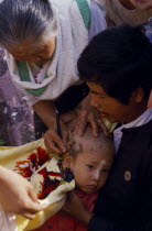 Ritual head shaving of initiate monk. Burma