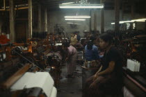 Female labour in sweatshop textile factory.