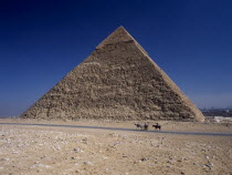 Tourist horse and carriage passing by pyramid of Khufu.