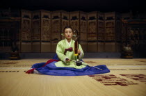 Woman playing traditional stringed instrument