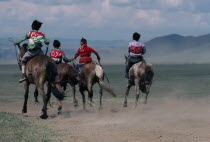 National Day horse race with boy jockeys racing across the plains