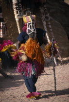 Masked Dogon dancer performing a ritual funeral dance. West Africa