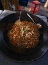 A wok full of mee goreng a traditional spicey noodle dish on a stall at the Night Market in Cenang