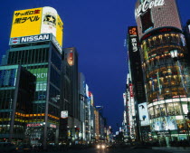 Ginza at night  view along road with illuminated signs/bldgs