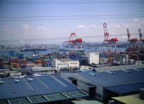 Aerial view over the docks with warehouses  containers  cranes and ships.