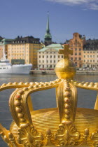 Close-up of an ornamental crown on Skeppsholmsbron with Gamla Stan in the background.travelScandinaviaSwedenStockholmNorthern Europe Swedish European