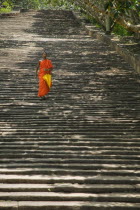 A lone monk descending The Stairway  1840 granite steps that lead up to the dagobas and shrines at the top of the hill.shrinetravelSri LankaAsiaBuddhaBuddhismmonk Asian Llankai Sri Lankan