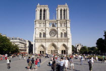 Tourists in the Place du Parvis Notre Dame in front of the west front of the Gothic Cathedral of Notre Dame on the Ile de la CiteFrench Western Europe European