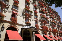 The facade of the five star Hotel Plaza Athenee on the Avenue Montagne in the heart of the haute couture fashion district with red geraniums in window boxes and red awningsFrench Western Europe Europ...