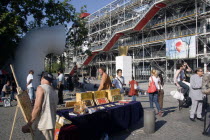 Artists selling their work amongst tourists in the Place Georges Pompidou in front of the Pompidou Centre in Beauborg Les HalleFrench Western Europe European