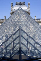 The pyramid entrance to the Musee du Louvre beside the Richelieu PavilionFrench Western Europe European Gray Grey Holidaymakers Pavilion Tourism Tourist Pavillion Sightseeing Tourists