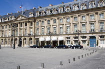 Limousines parked at the front of the Ritz Hotel in Place Vendome with the French Tricolour flying from a flagpole above the Ministry of Justice next doorFrench Western Europe European