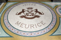 A mosaic with a crest and the words Hotel Meurice on the pavement outside the entrance door to the five star hotel in the Rue de RivoliFrench Western Europe European