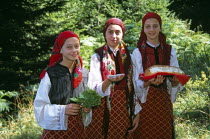 Girls dressed in Bulgarian national costume holding bread  salt and leaves.near Bansko  TravelTourismHolidayVacationExploreRecreationLeisureSightseeingTouristAttractionTourChalinValogBan...