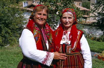 Member of Dobarski Babi Folk Group  and tourist on right  in national costumeTravelTourismHolidayVacationAdventureExploreRecreationLeisureSightseeingTouristAttractionTourDobarskoBanskoB...