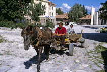 Couple on horse and cart and Paisii of Hilendar Monument.Equestrian TravelTourismHolidayVacationExploreRecreationLeisureSightseeingTouristAttractionTourBanskoBulgariaBulgarianHotWarmS...