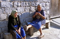 Two old ladies sitting on bench knitting.TravelTourismHolidayVacationExploreRecreationLeisureSightseeingTouristAttractionTourBanskoBulgariaBulgarianLadyLadiesWomanWomenFemalePerson...